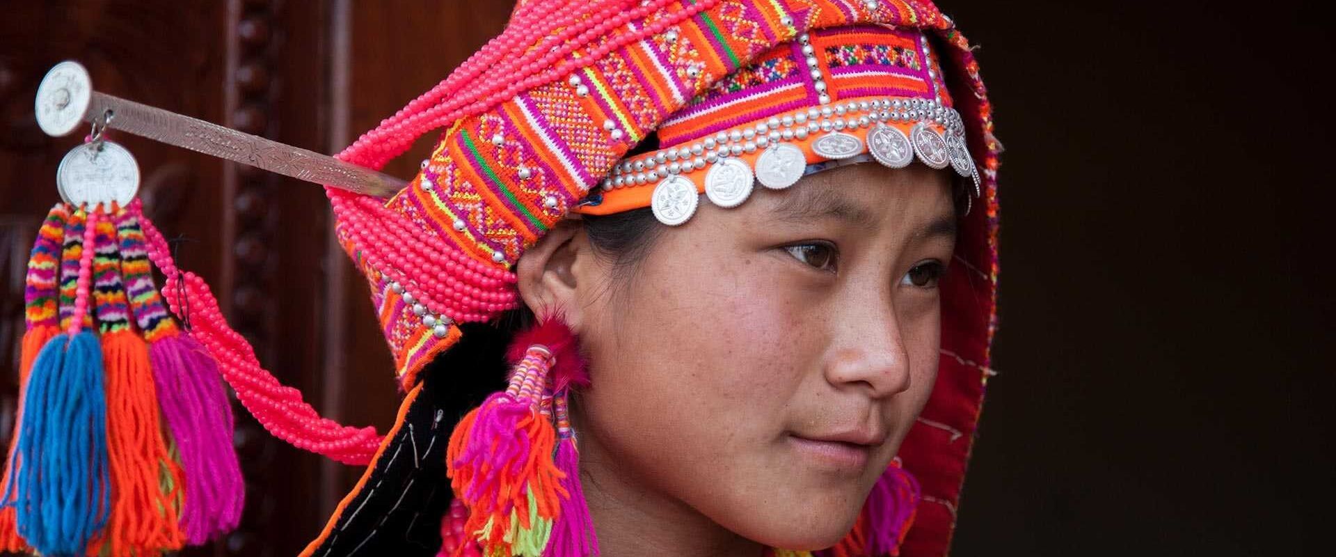 Misty Oudomxay ethnic girl at dawn for an Oudomxay Tours banner by Legend Travel Group.